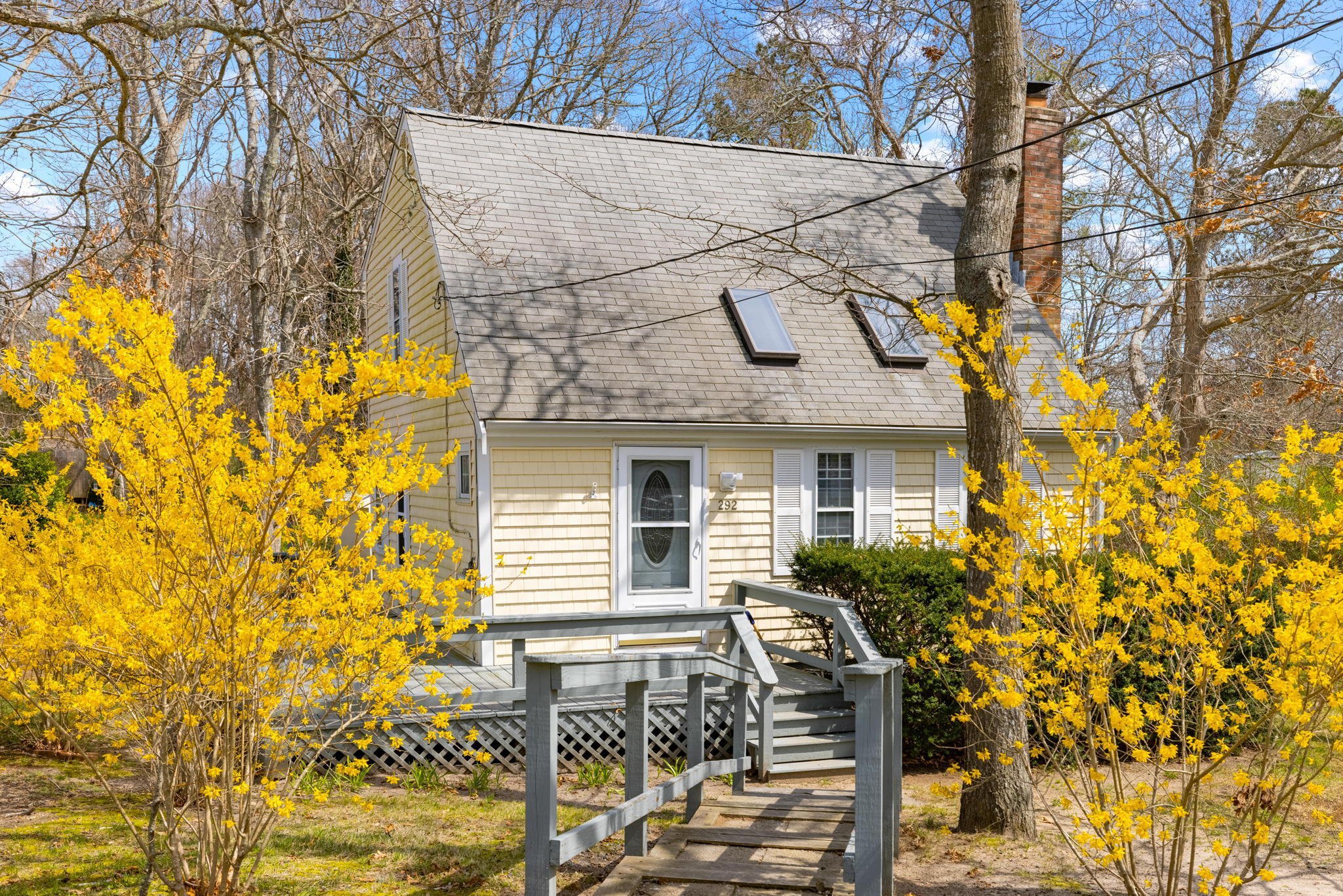 a front view of a house with large garden