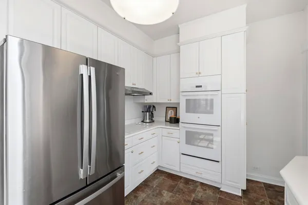 a utility room with cabinets washer and dryer