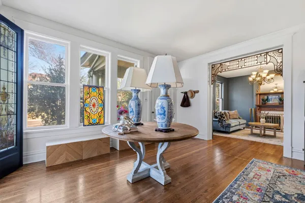 a living room with furniture a table and a large window