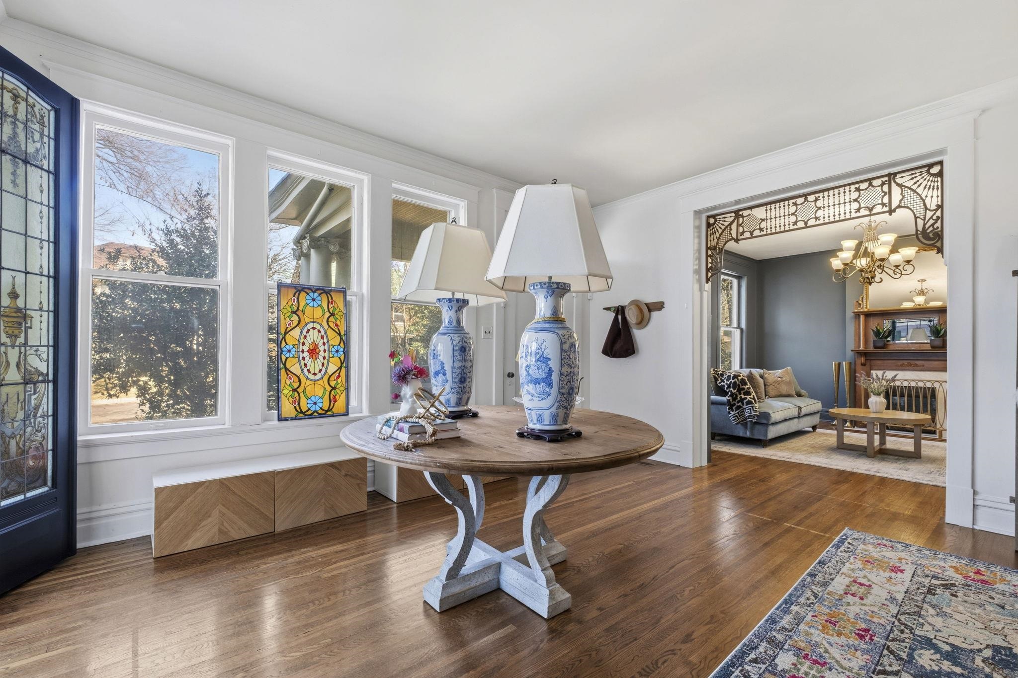 1273 Carr Avenue Memphis, TN 38104 - Photo 7 of 39 Large windows fill the living room with natural light while highlighting the home’s historic character.