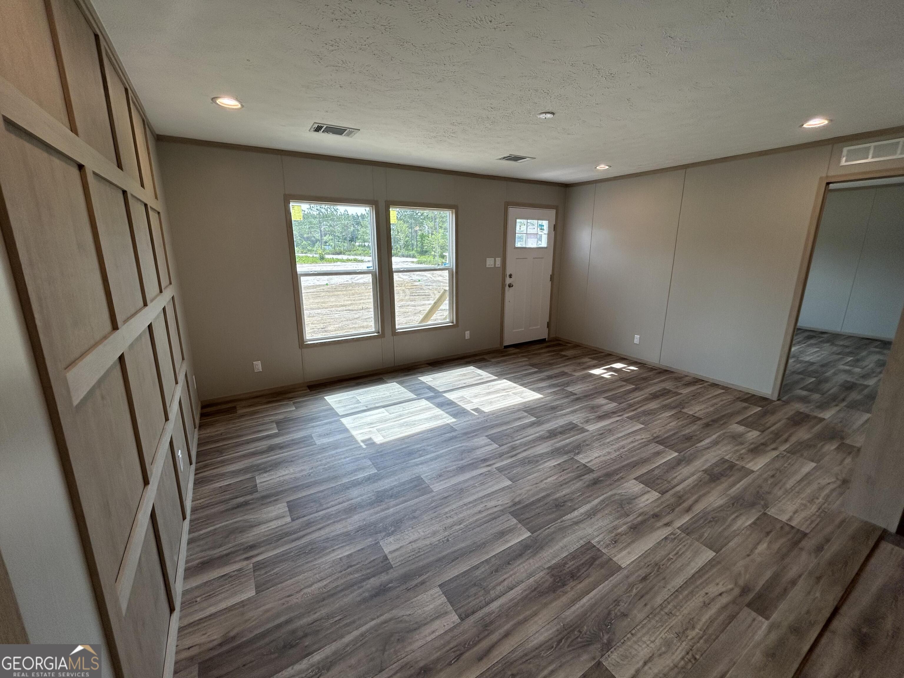 640 Elmer Thrift Road Waycross, GA 31503 - Photo 14 of 23 a view of empty room with wooden floor and fan