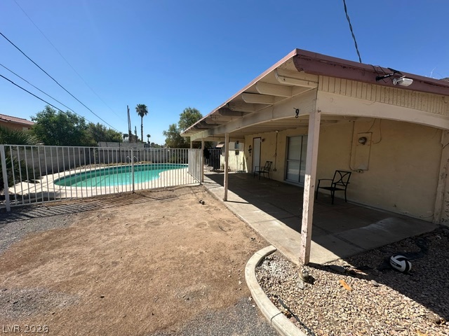 3322 South Pecos Road Las Vegas, NV 89121 - Photo 15 of 16 A spacious covered patio overlooks the fenced in-ground pool under clear desert skies.