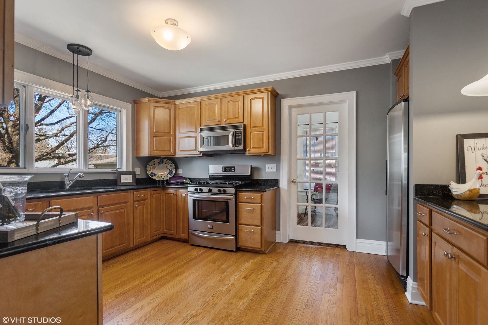 822 East Thacker Street Des Plaines, IL 60016 - Photo 7 of 20 a kitchen with stainless steel appliances granite countertop a stove top oven a sink dishwasher a refrigerator and a microwave oven with wooden floor