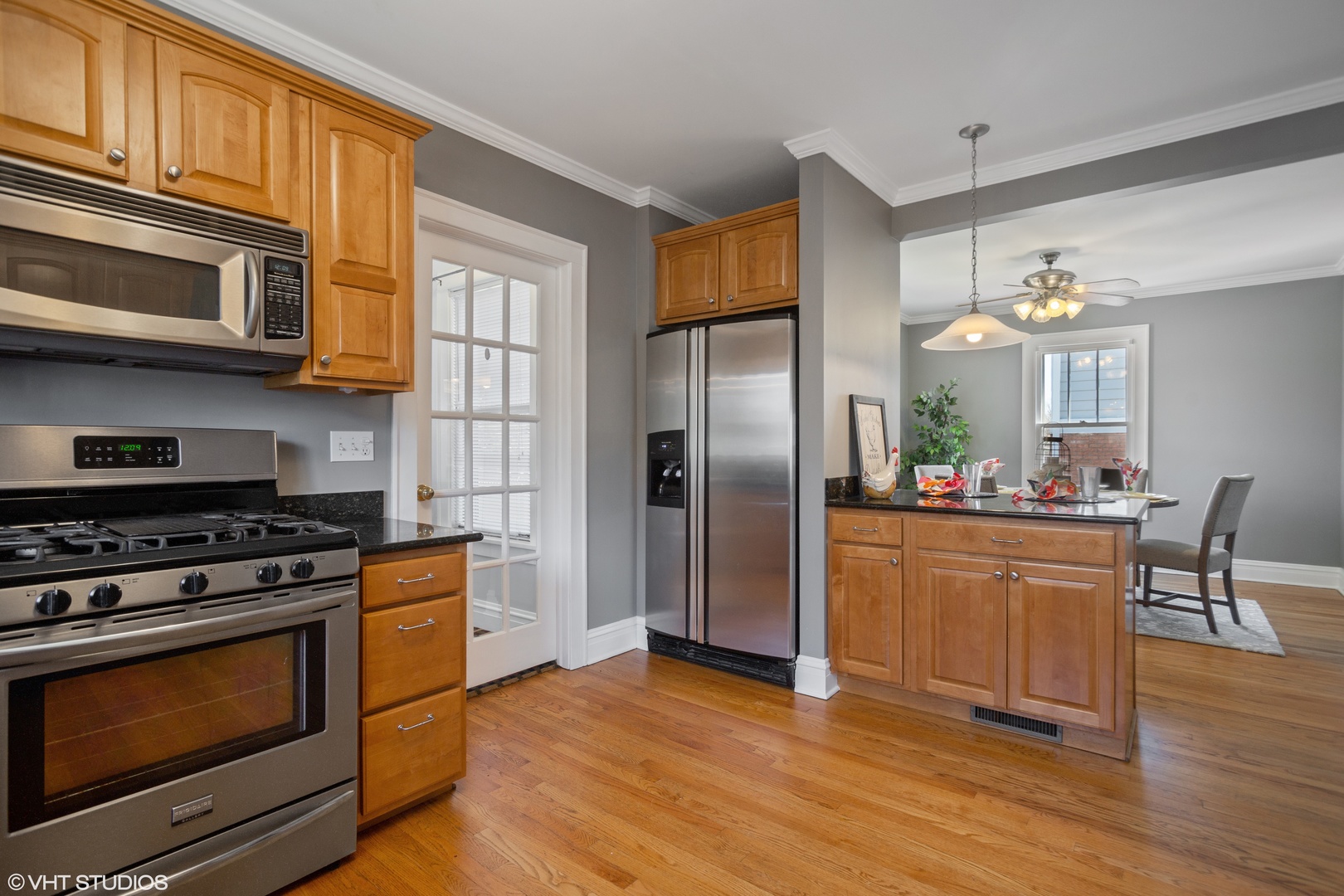 822 East Thacker Street Des Plaines, IL 60016 - Photo 8 of 20 a kitchen with stainless steel appliances granite countertop a stove top oven a refrigerator and a sink with granite countertops