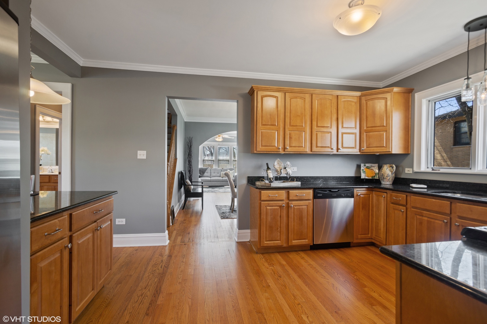 822 East Thacker Street Des Plaines, IL 60016 - Photo 9 of 20 a kitchen with stainless steel appliances granite countertop wooden cabinets a refrigerator a sink a stove a microwave and wooden floors
