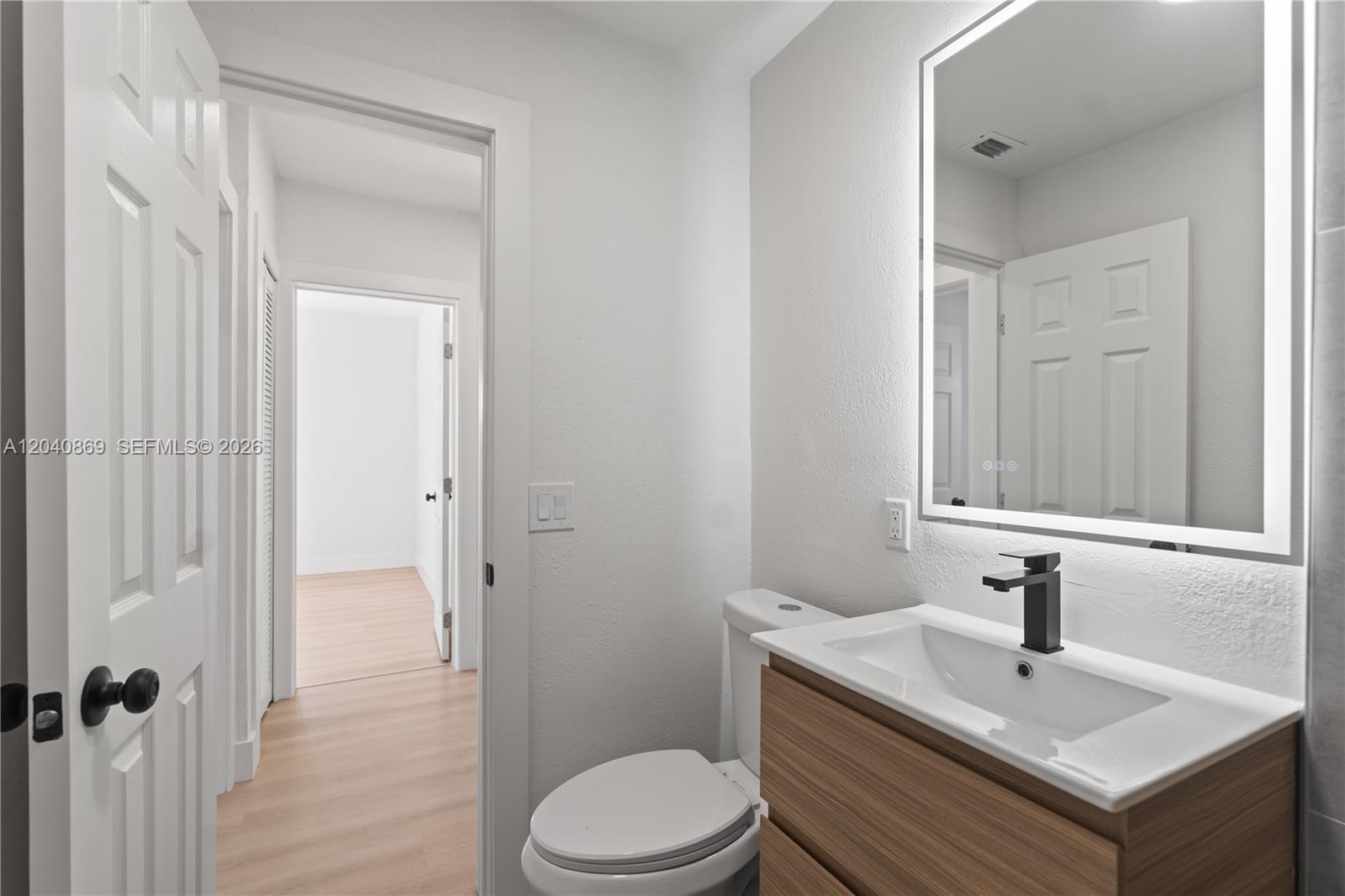 31 West 64th Street Hialeah, FL 33012 - Photo 40 of 49 a bathroom with a sink toilet and vanity