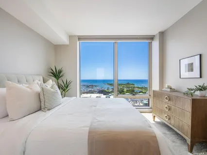 a bedroom with a large bed and a window