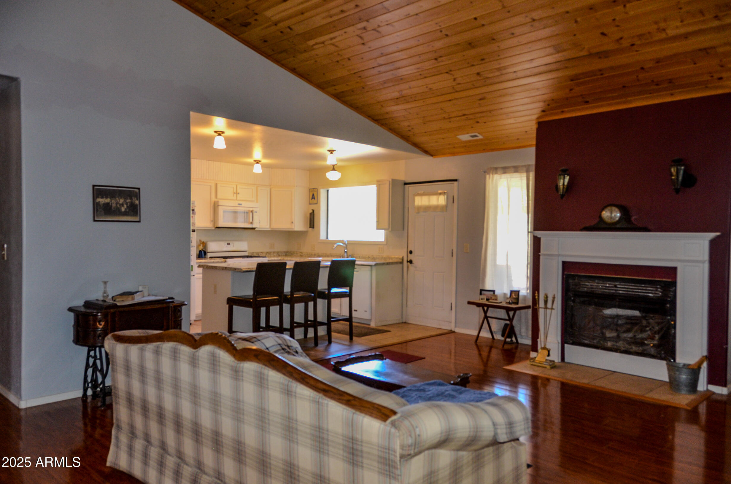 685 Kuhn Road Pinedale, AZ 85934 - Photo 18 of 74 a living room with furniture a fireplace and a table