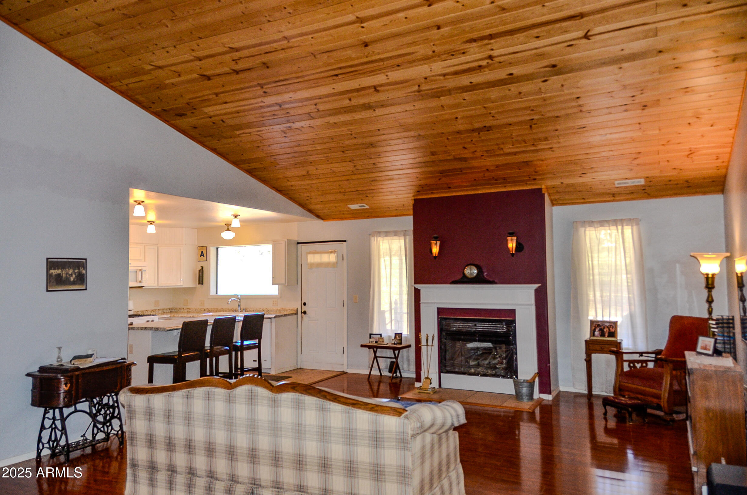 685 Kuhn Road Pinedale, AZ 85934 - Photo 19 of 74 a living room with furniture a fireplace and a table