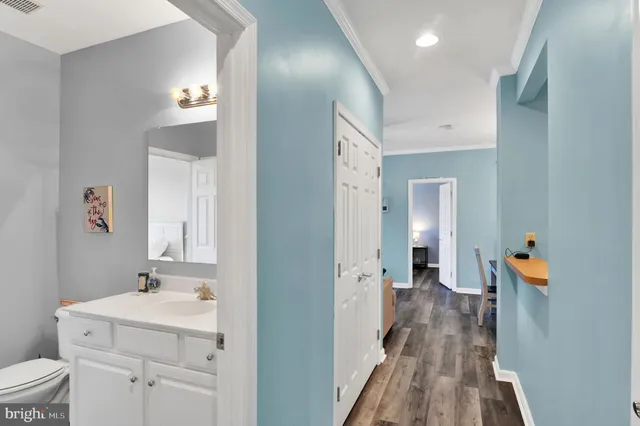 a view of a dining room with furniture a chandelier and wooden floor