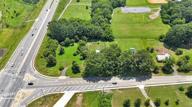 a view of a swimming pool with a yard and plants