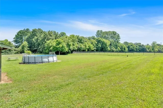 a view of a large yard with a large tree and a park