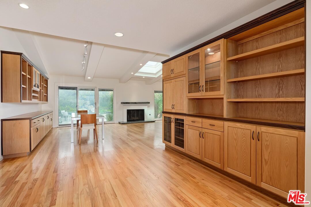18409 Wakecrest Drive Malibu, CA 90265 - Photo 11 of 32 a living room with stainless steel appliances granite countertop furniture wooden floor and a fireplace