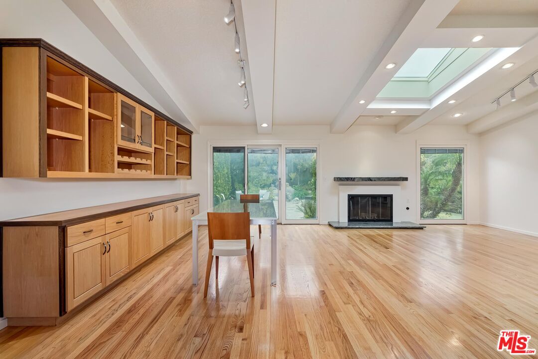 18409 Wakecrest Drive Malibu, CA 90265 - Photo 15 of 32 a view of an empty room with wooden floor and a fireplace