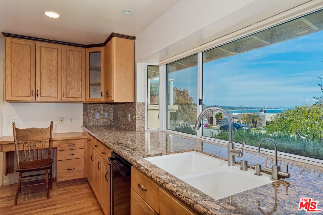 18409 Wakecrest Drive Malibu, CA 90265 - Photo 6 of 32 a kitchen with stainless steel appliances granite countertop a sink and cabinets