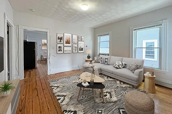 a living room with furniture and wooden floor