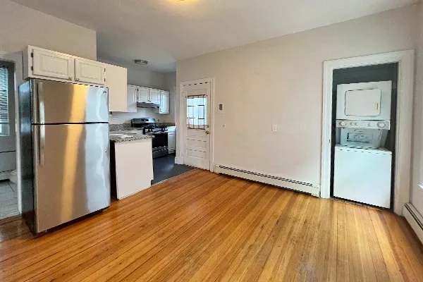 a kitchen with stainless steel appliances a refrigerator and wooden floor