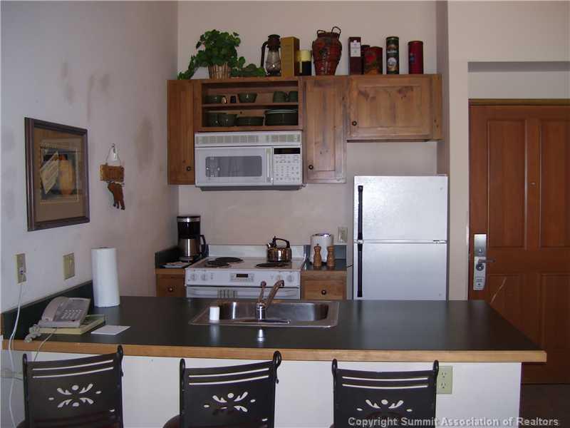 195 River Run Road, Unit 8074 Keystone, CO 80435 - Photo 6 of 21 a kitchen with a stove and a refrigerator