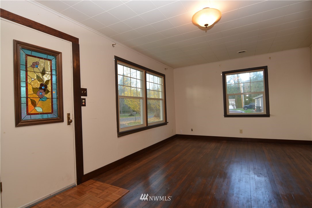 116 Dungan Road Kelso, WA 98626 - Photo 3 of 40 a view of an empty room with wooden floor and a window
