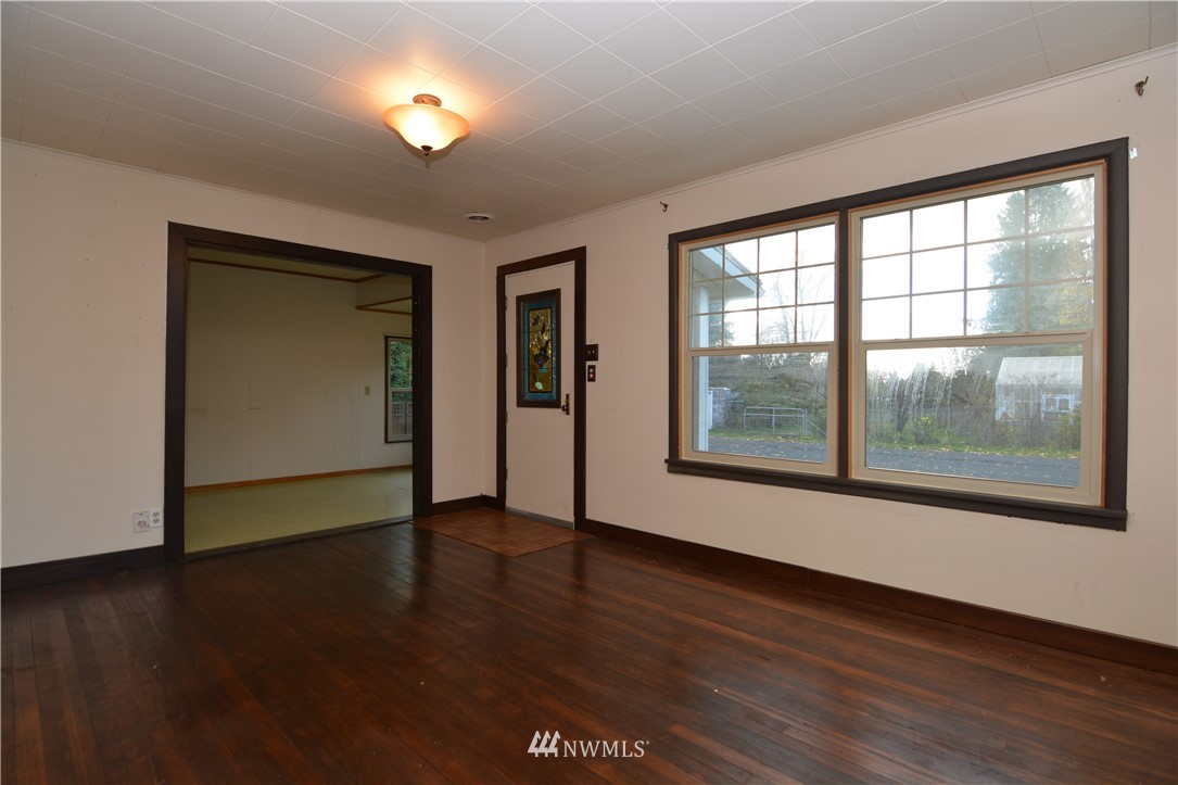 116 Dungan Road Kelso, WA 98626 - Photo 4 of 40 a view of an empty room with wooden floor and a window