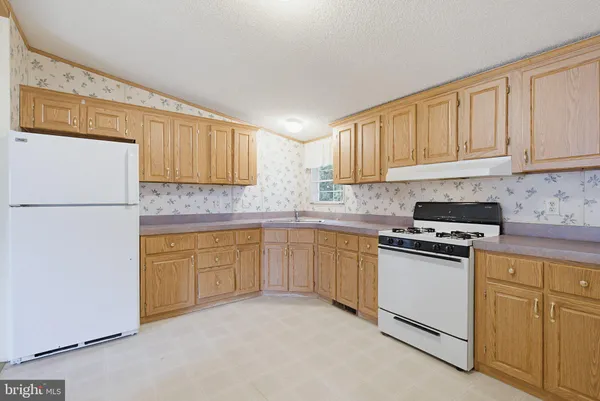 a kitchen with granite countertop cabinets stainless steel appliances and a sink