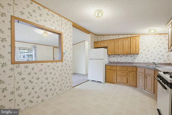 a spacious bathroom with a granite countertop sink a bathtub and shower