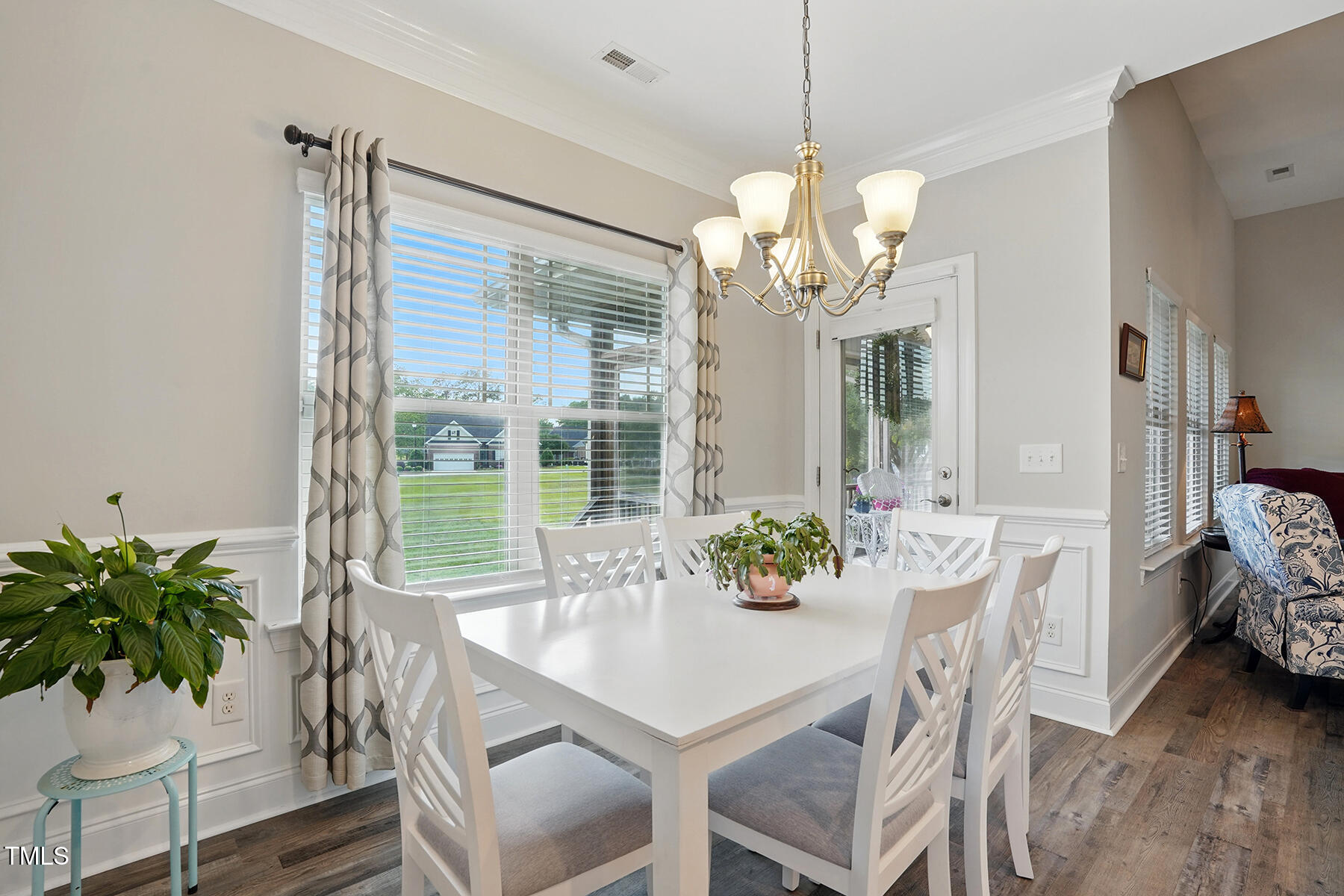 116 Colonade Court Benson, NC 27504 - Photo 12 of 37 a dining room with furniture potted plants and wooden floor