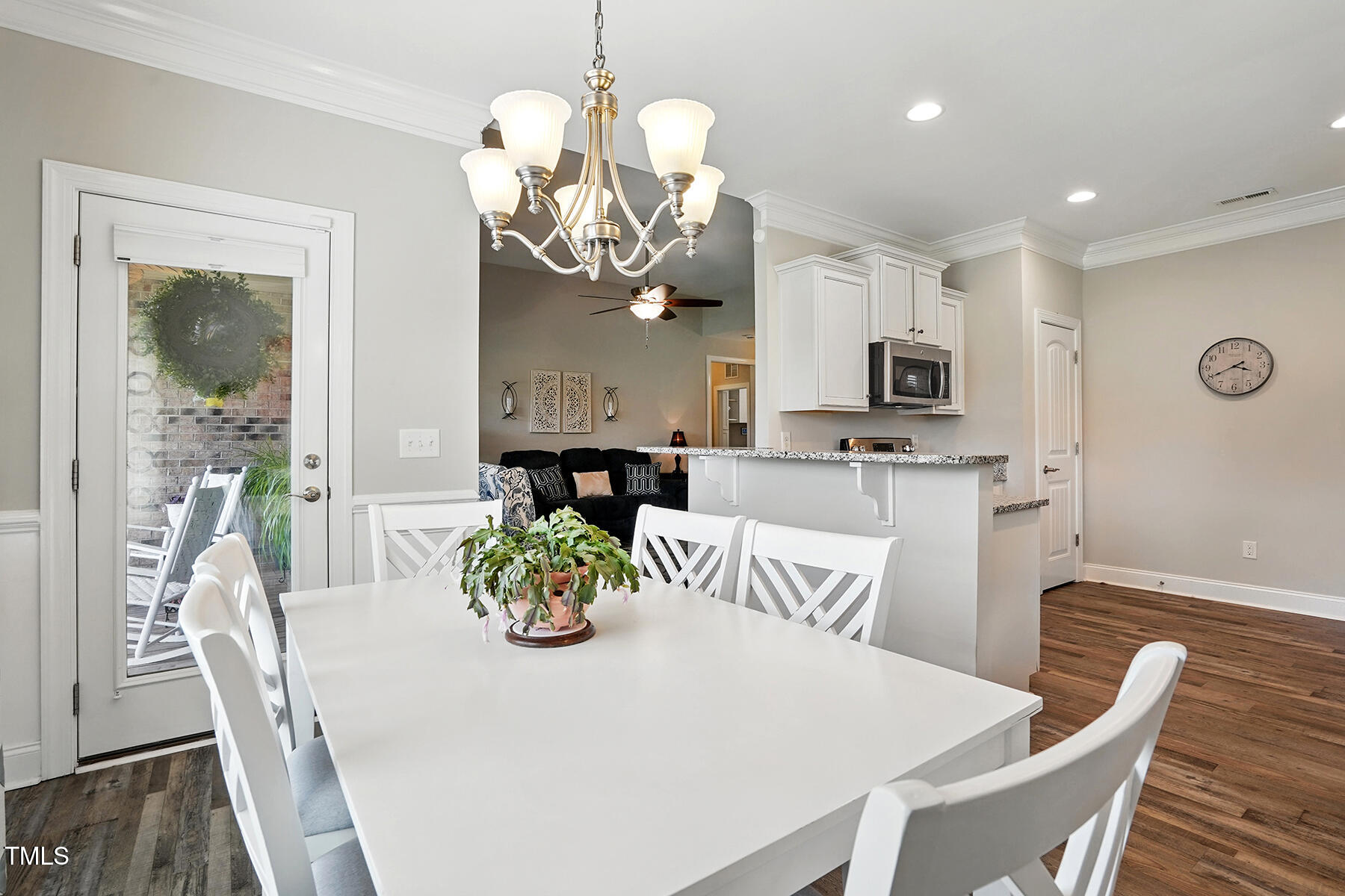 116 Colonade Court Benson, NC 27504 - Photo 13 of 37 a view of a dining room with furniture a chandelier and wooden floor