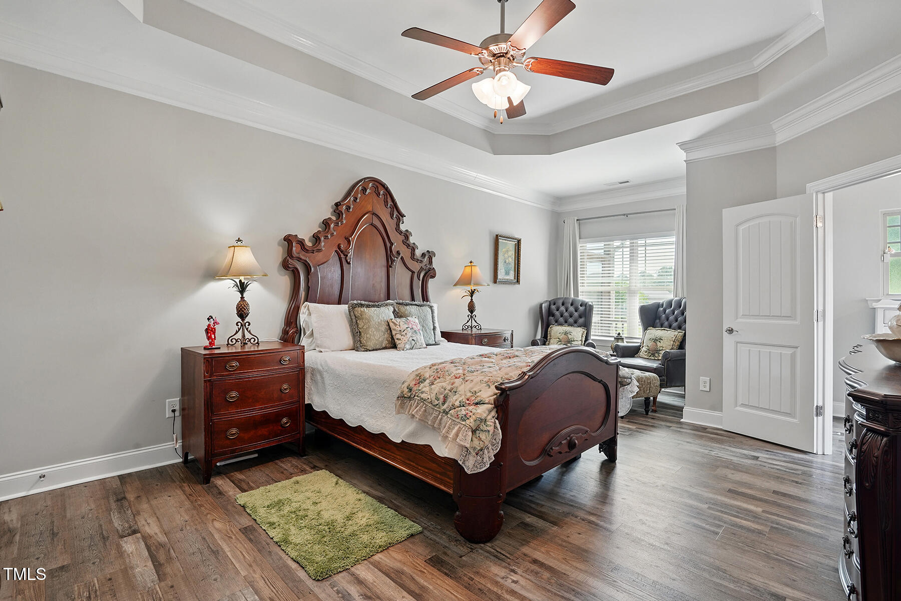 116 Colonade Court Benson, NC 27504 - Photo 17 of 37 a bedroom with a bed and a chandelier