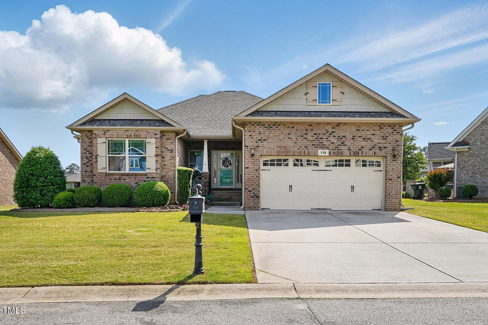 116 Colonade Court Benson, NC 27504 - Photo 2 of 37 a front view of a house with a yard and garage