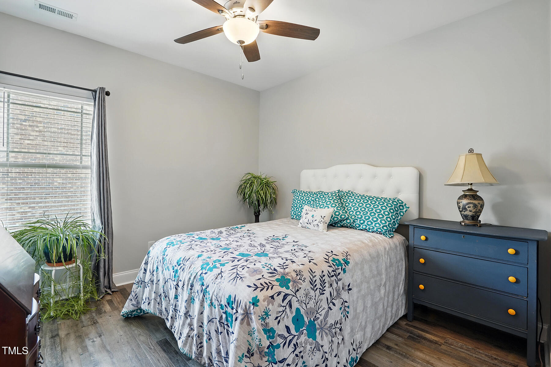 116 Colonade Court Benson, NC 27504 - Photo 22 of 37 a bedroom with a bed and a potted plant