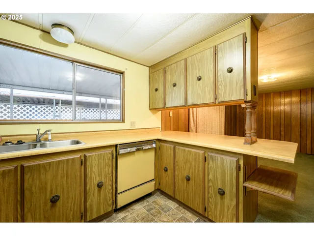 a white refrigerator freezer and a stove sitting inside of a kitchen
