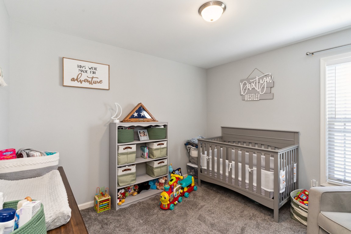 957 Jimtown Road Lafayette, TN 37083 - Photo 13 of 25 a bedroom with furniture and a baby crib