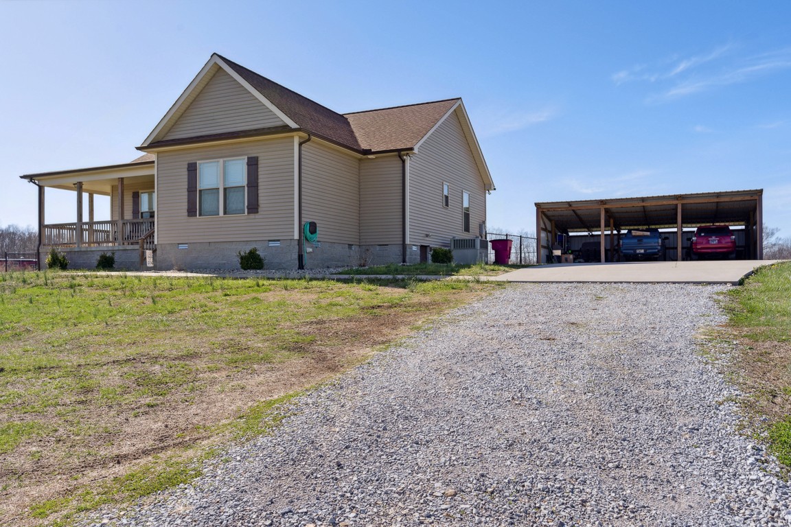 957 Jimtown Road Lafayette, TN 37083 - Photo 3 of 25 a view of a house with a yard and garage
