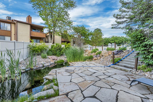 6852 Countrywoods Circle, Unit 5D Midvale, UT 84047 - Photo 45 of 50 Flagstone patio featuring a water feature, tiered landscaping, and concrete steps