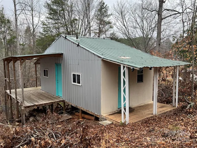a backyard of a house with barbeque oven table and chairs