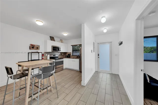 a open kitchen with cabinets and stainless steel appliances