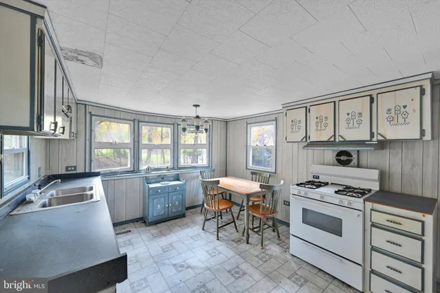 a kitchen with furniture a stove and a refrigerator