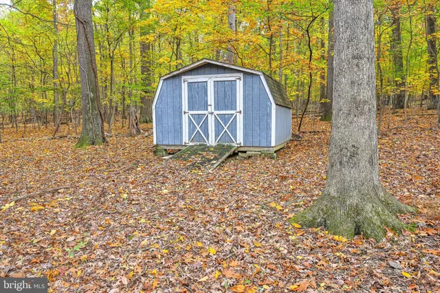 a view of a wooden door in front of a house