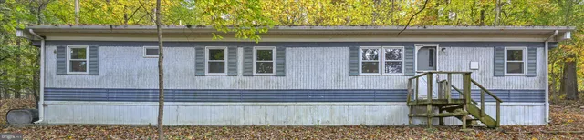 a view of a house with a window and wooden fence