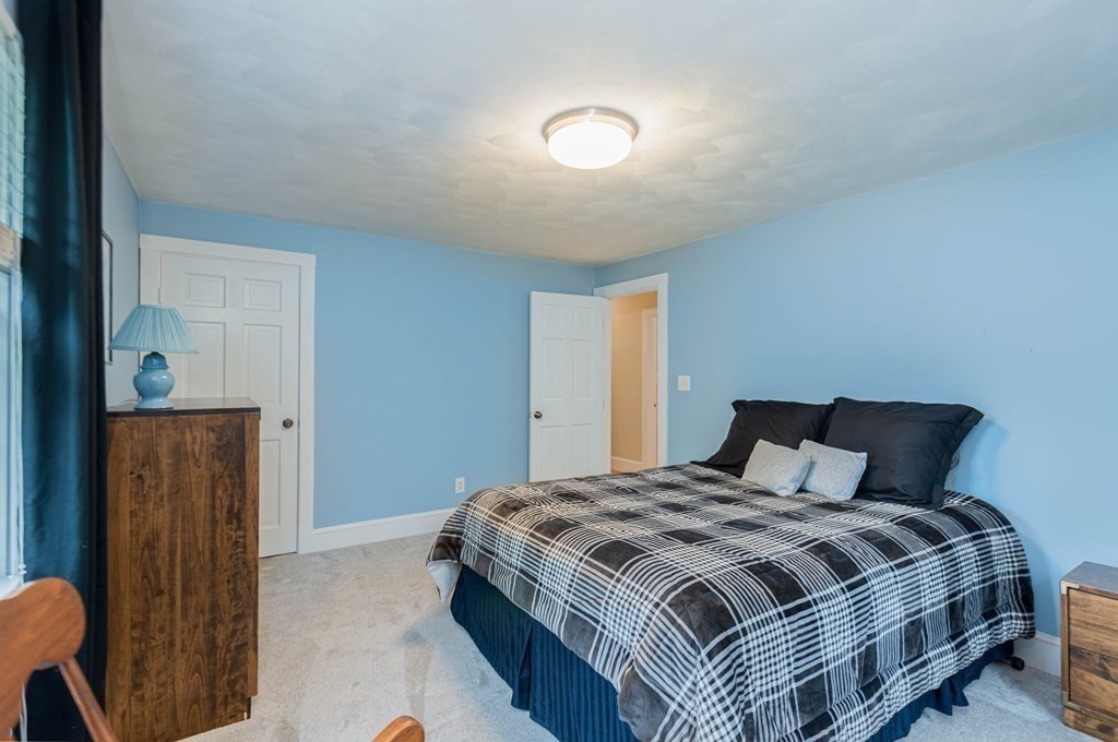 17 Norwood Road Salem, NH 03079 - Photo 19 of 24 a bedroom with a bed and wooden floor