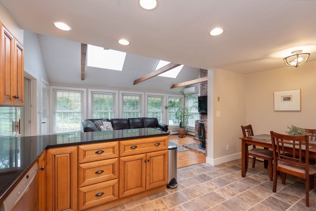 17 Norwood Road Salem, NH 03079 - Photo 4 of 24 a kitchen with granite countertop a sink and chairs