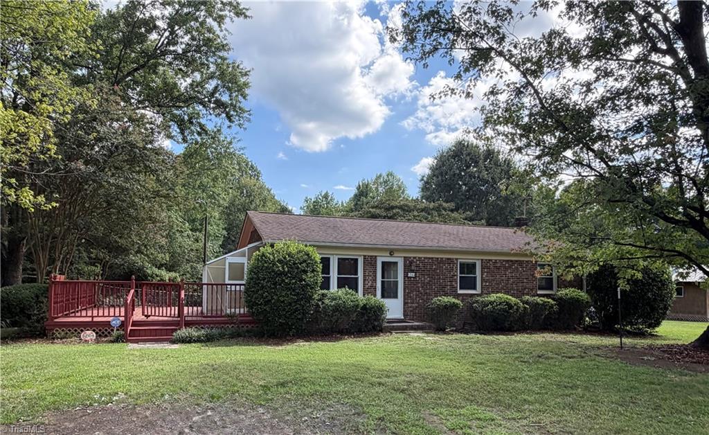 5264 Hopkins Road Browns Summit, NC 27214 - Photo 1 of 40 Front of brick ranch with mature landscaping, hardwoods & large space go grassy area