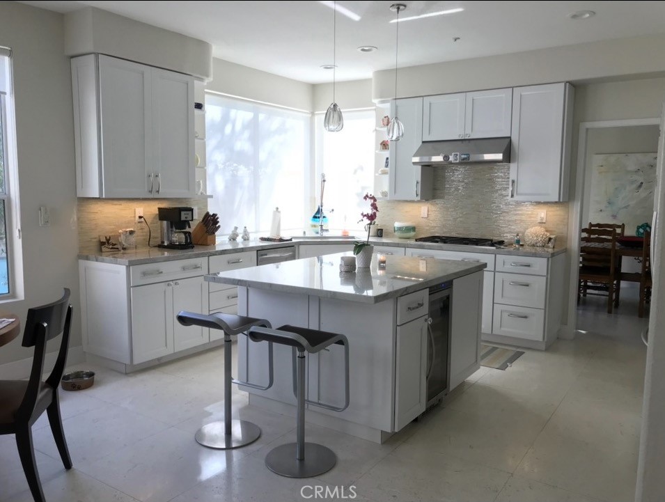 1625 Via Sage San Clemente, CA 92673 - Photo 4 of 4 a kitchen with stainless steel appliances granite countertop a table chairs sink and cabinets