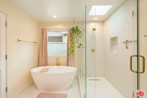a bathroom with a bathtub and shower