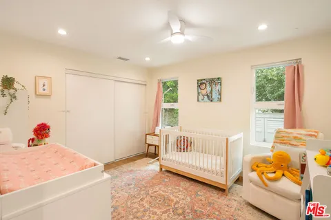 a bedroom with furniture and a window