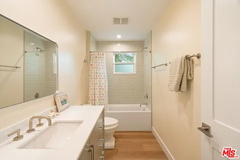 a bathroom with a sink toilet tub and shower
