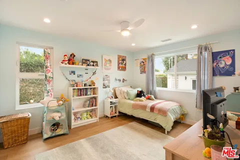 a bedroom with furniture and a window