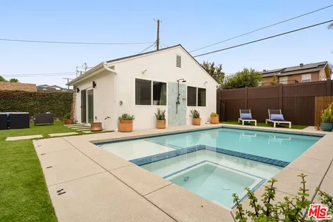 a view of a backyard with a patio and a garden