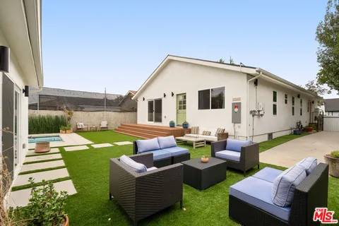 a view of a house with backyard and a patio